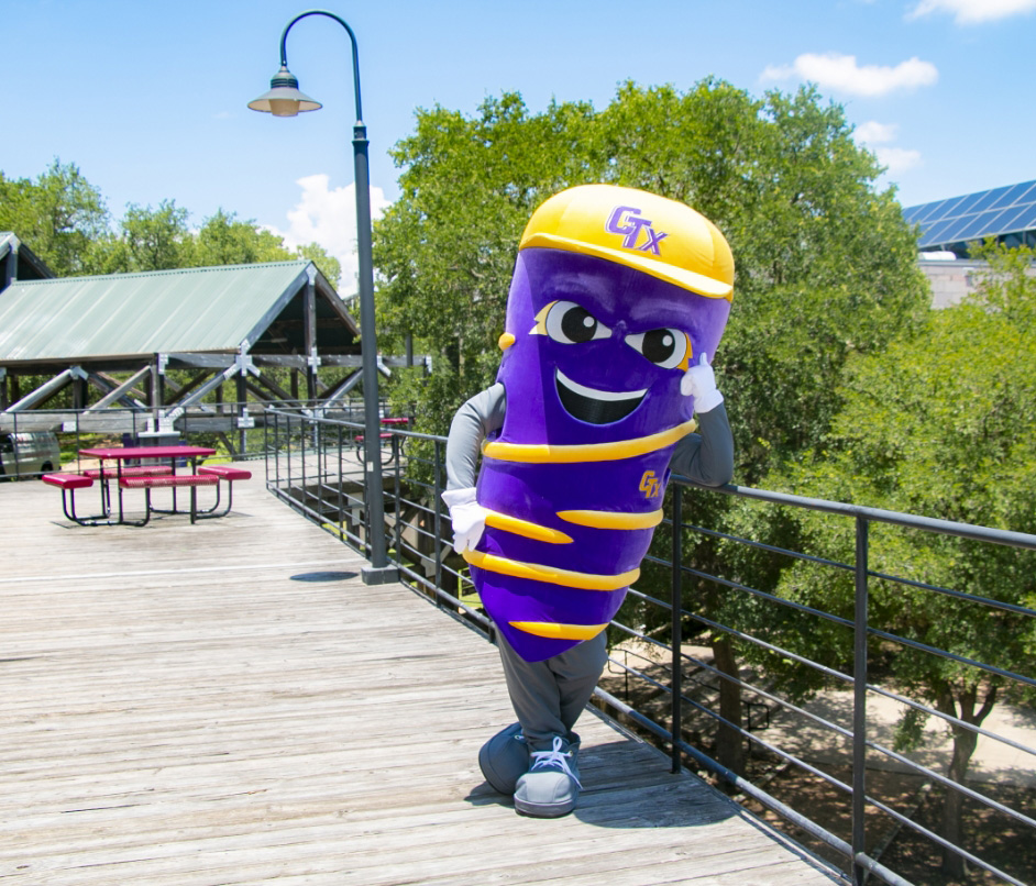 VortTex, the school mascot, standing outside on a wooden deck at Concordia University Texas in Austin, Texas