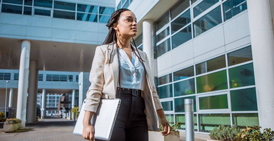 Public health professional wearing business clothes in a hospital setting.