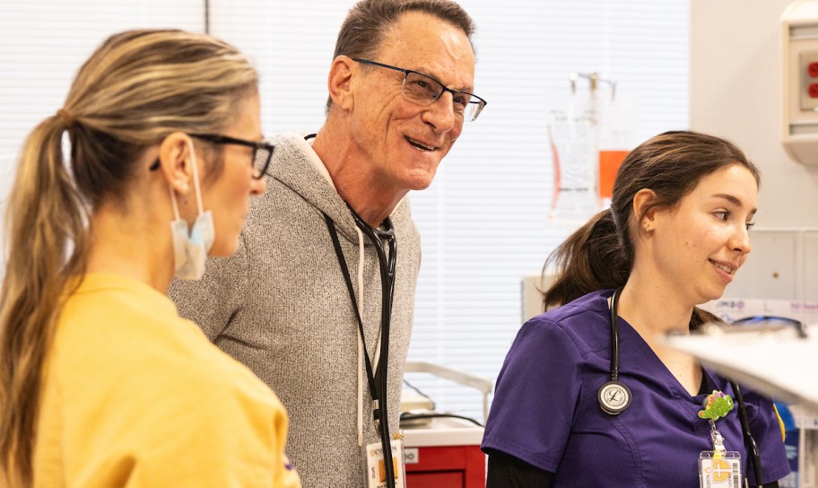 A professor advising in a simulation lab