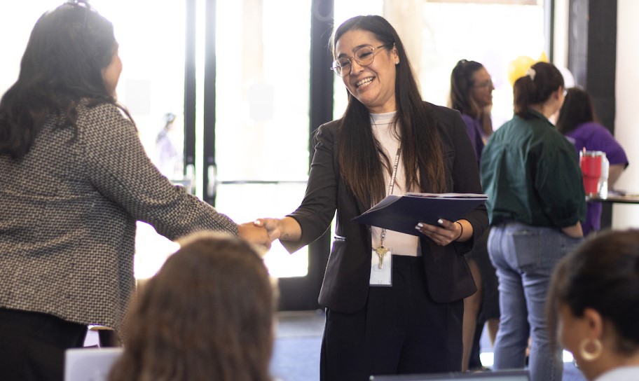 Two women shaking hands