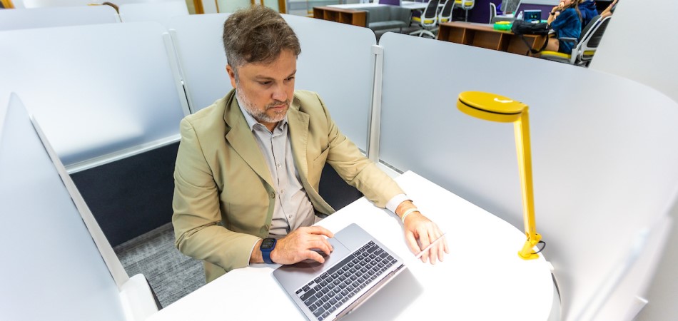 A graduate student working in the study room