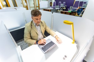 A graduate student working in the study room