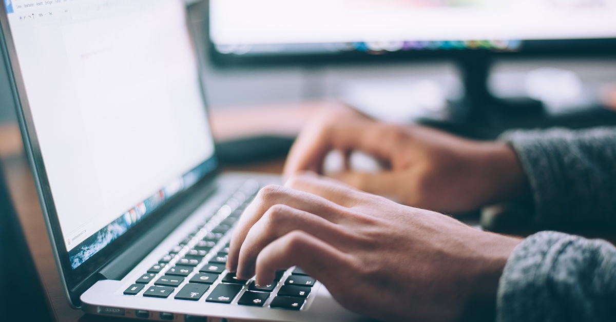 Student Typing On Laptop