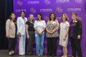 A group of Concordia staff awarding a local counselor for her work in the community