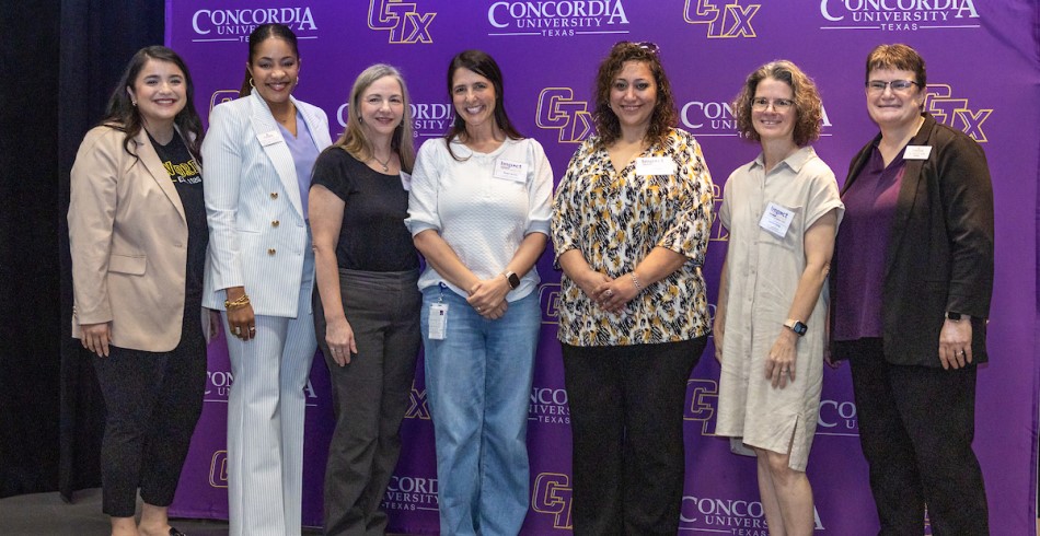 A group of Concordia staff awarding a local counselor for her work in the community
