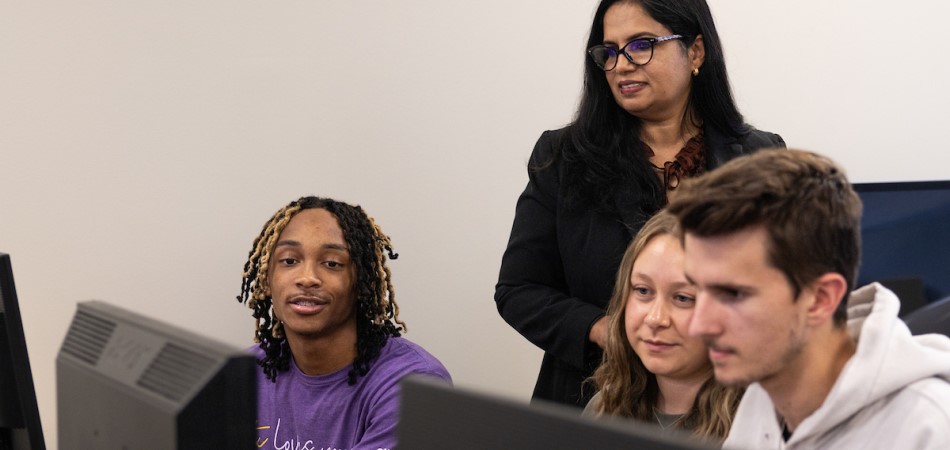 Dr. George helping students in a computer lab
