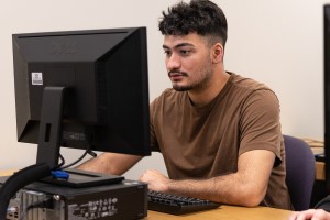A student working on an MCS project in a computer lab