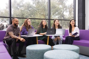 A group of MBA students working together on campus