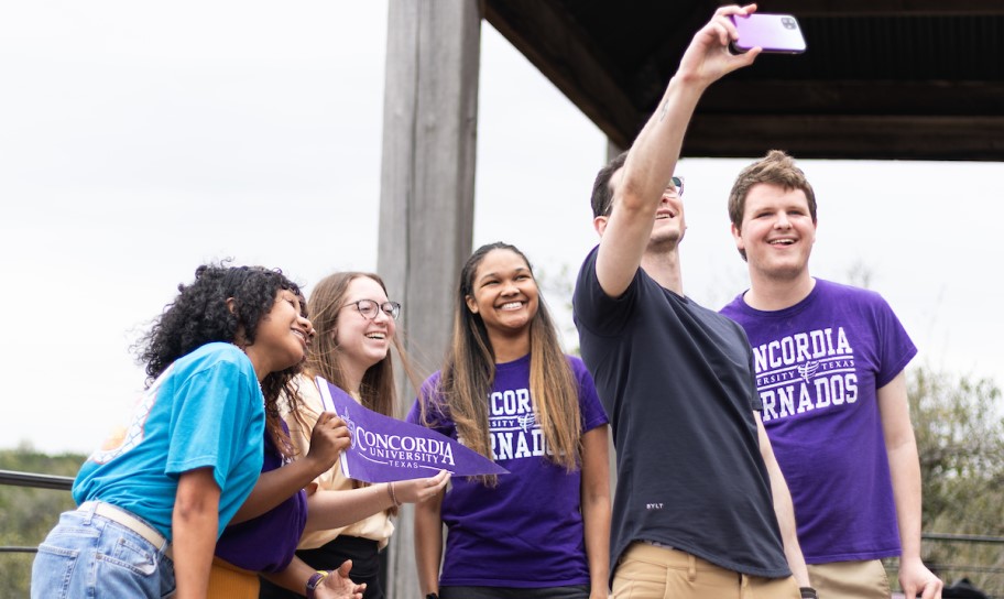 Students taking a group selfie on campus